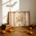 Autumn leaf wall art styled with pumpkins and vintage books