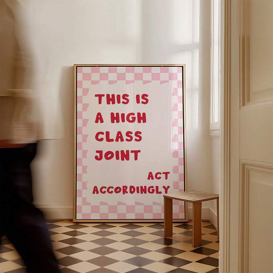 Large pink checkerboard quote poster displayed in bright hallway with checkered floor
