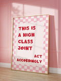 Close view of red quote lettering and pink checkerboard poster against paneled wall