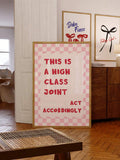 High class joint typography print leaning beside wood cabinet in layered living room decor