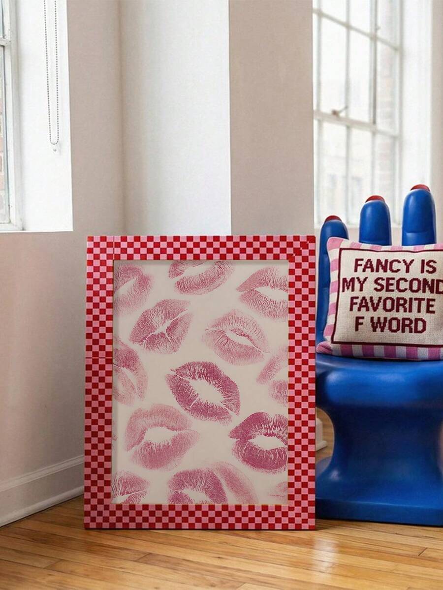 Lip print poster with red checkerboard frame beside blue chair