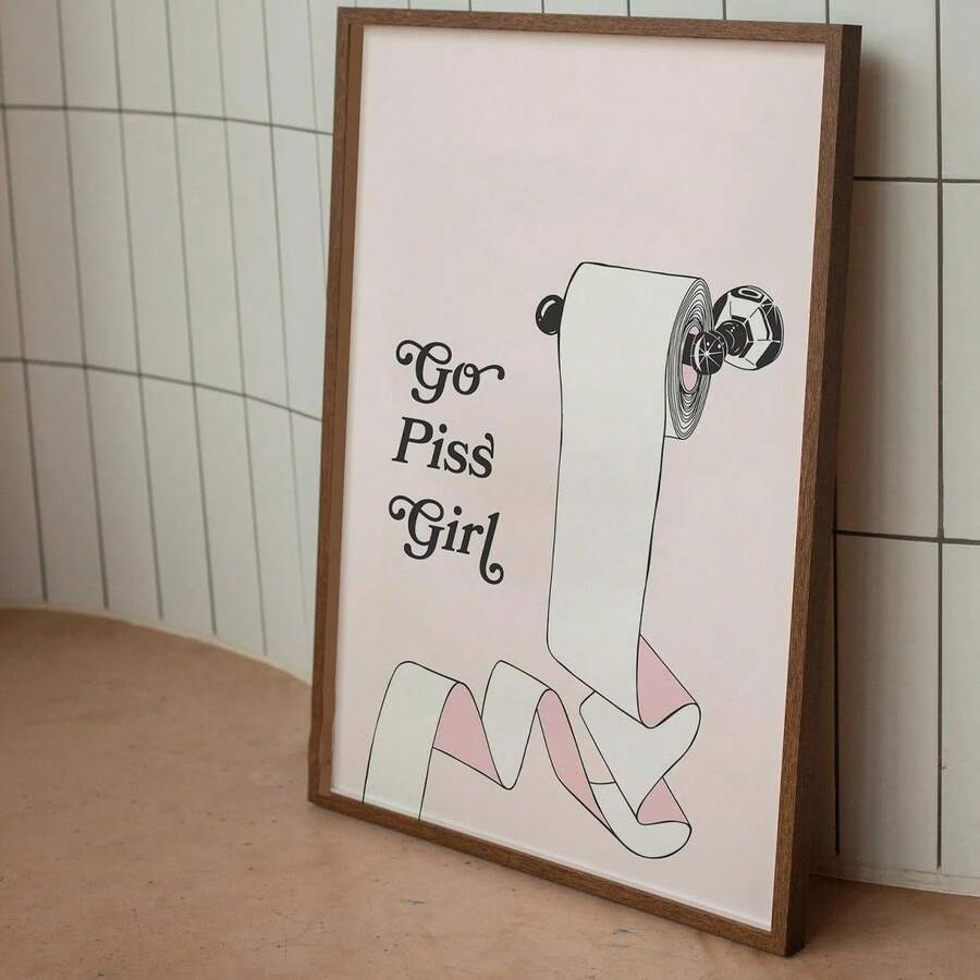 Funny toilet paper quote art leaning against tiled bathroom wall