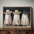 Ivory ghosts in pink tan and black cowboy hats displayed in a slim wood frame