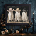 Three cowboy ghosts wall art in a dark wood frame with black candles and cream roses