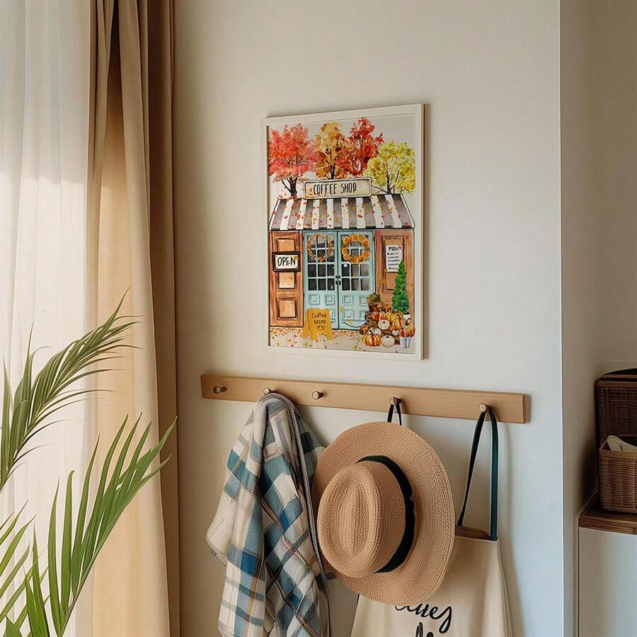 White framed autumn coffee shop artwork displayed above entryway hooks
