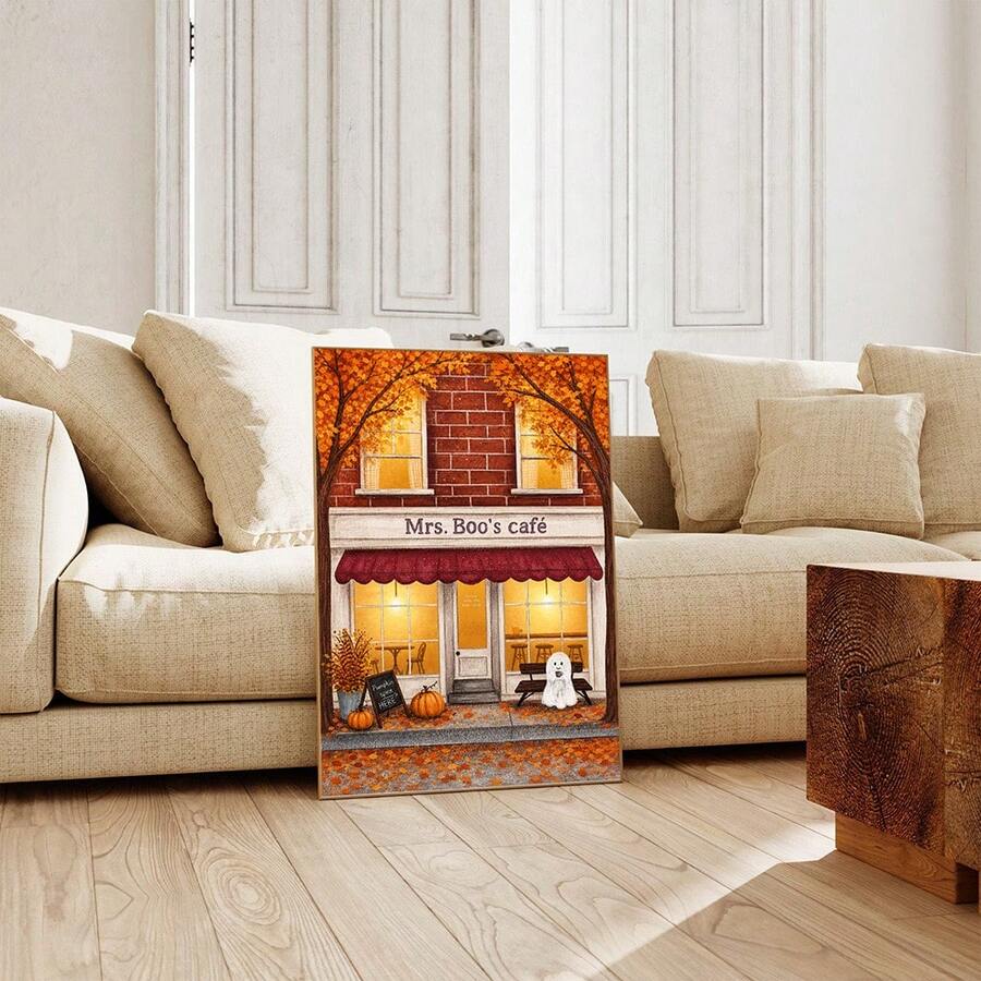 Unframed Mrs. Boo's cafe ghost print leaning against a cream living room sofa