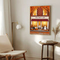 Framed Mrs. Boo's cafe Halloween print above a chair lamp and side table