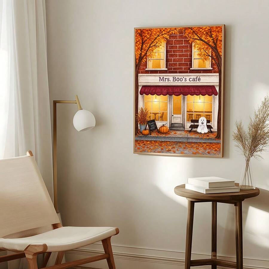 Framed Mrs. Boo's cafe Halloween print above a chair lamp and side table
