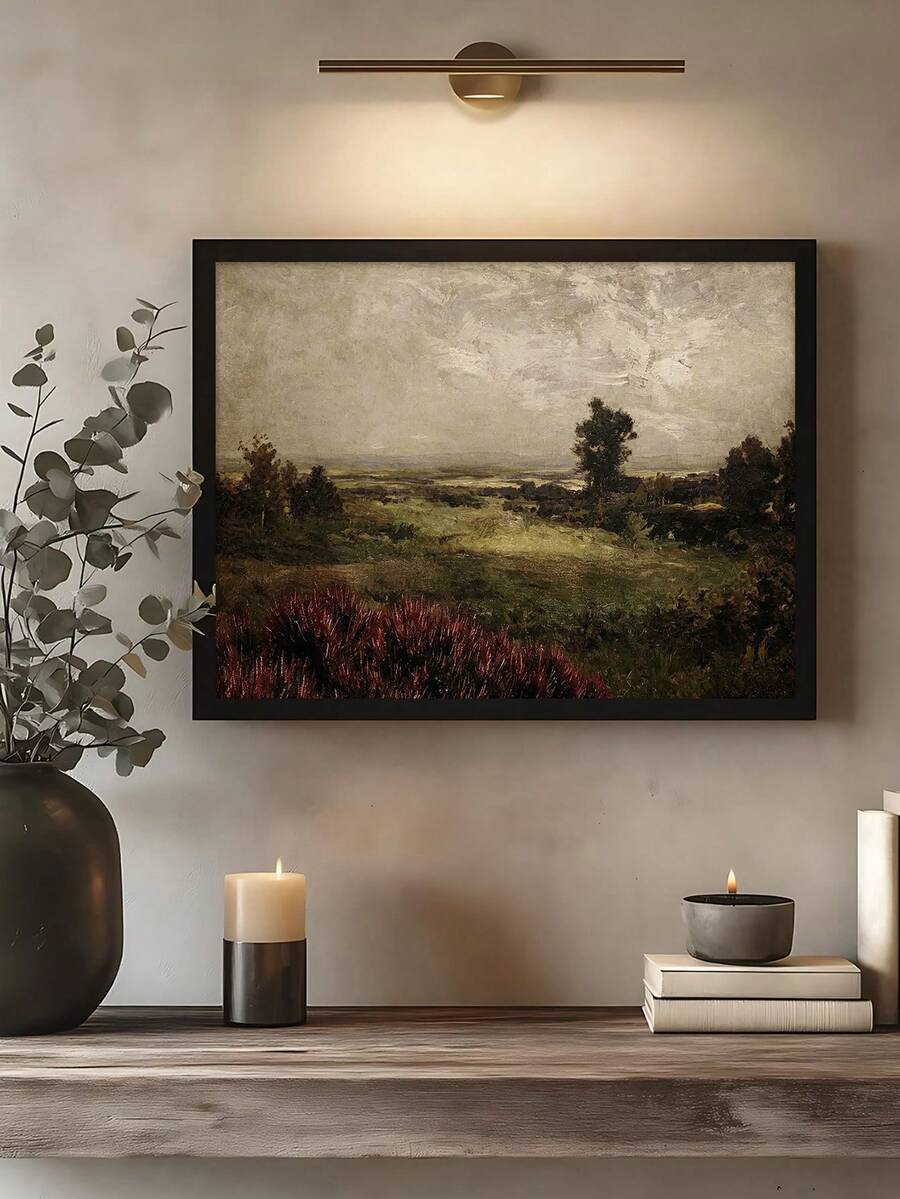 Moody pastoral landscape displayed in black frame under picture light