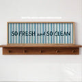 Playful clean-living wall art in navy blue and light teal