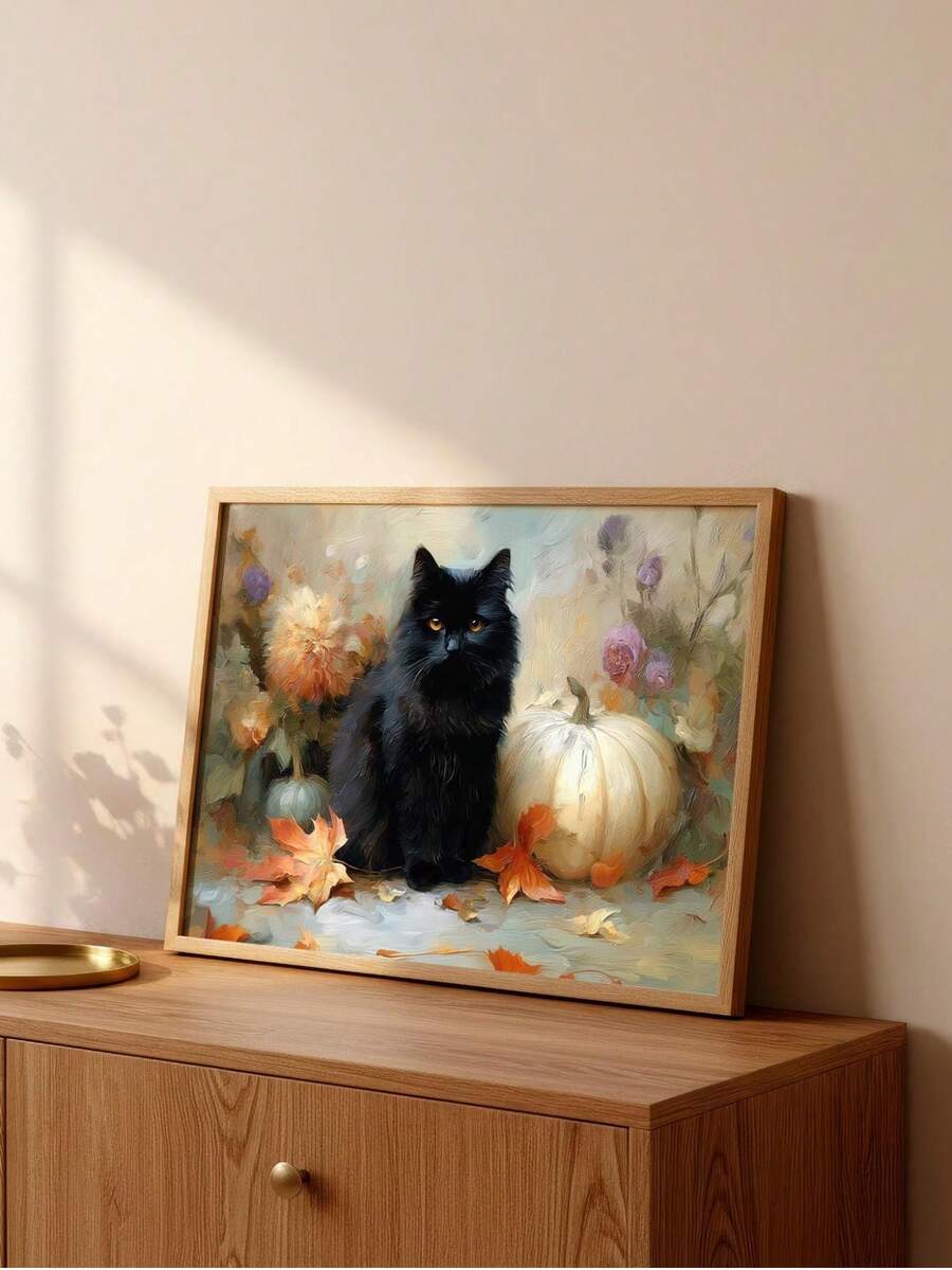 Light wood framed black cat and white pumpkin artwork leaning on sunlit wooden cabinet