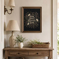 Haunted home botanical print above a rustic entry console with a lamp