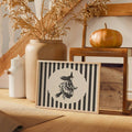 Mystical witch canvas poster styled with pumpkin, vase, branches, and wooden chair