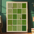 Green tiled figurative print in a light wood frame against a dark green wall