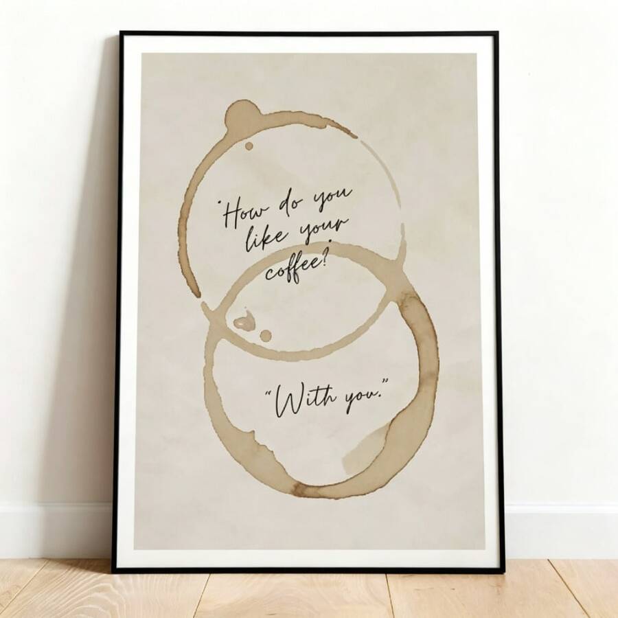 Framed coffee quote poster with brown mug-ring stains leaning beside a wood cabinet in neutral home decor