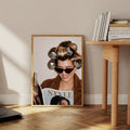 Smiling hair roller fashion portrait leaning beside a natural wood table