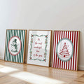 Framed vintage Christmas poster trio displayed against a wall