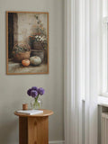 Framed autumn pumpkin still life beside white curtains and a round table