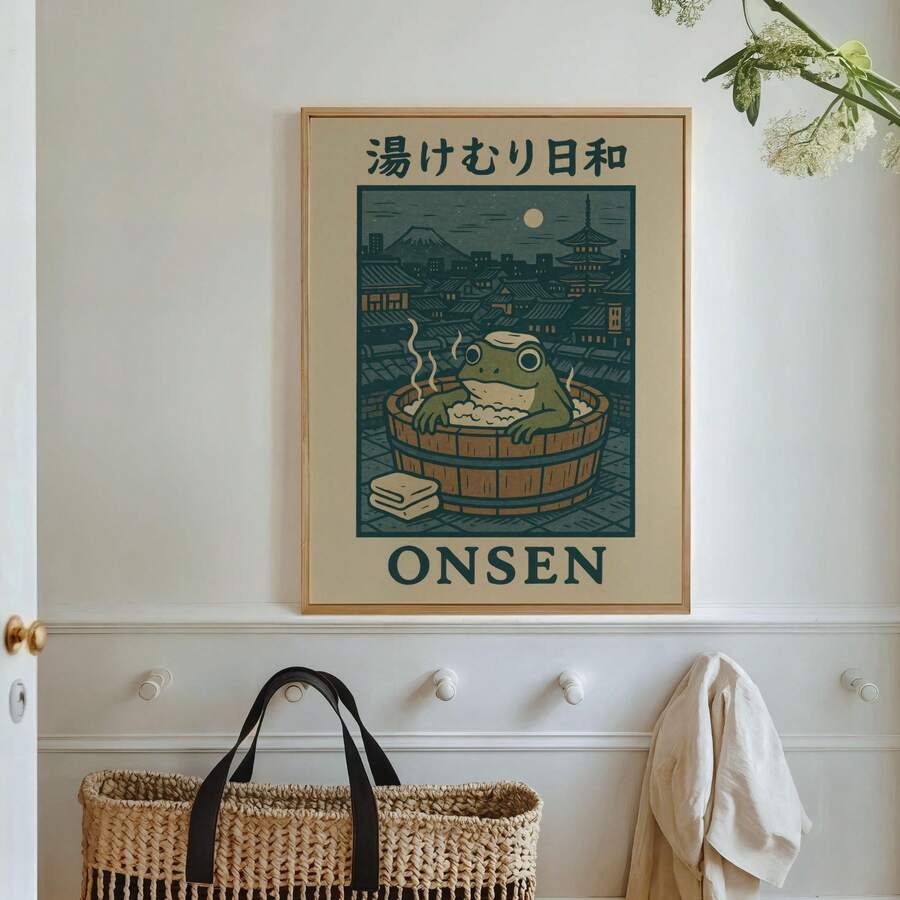 Natural wood-look framed onsen frog print beside open books and window blinds
