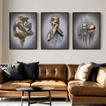 Dark-framed three-panel romantic figurative art displayed above caramel leather sofa
