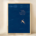 Vertical navy quote print with floating woman in a light wood frame