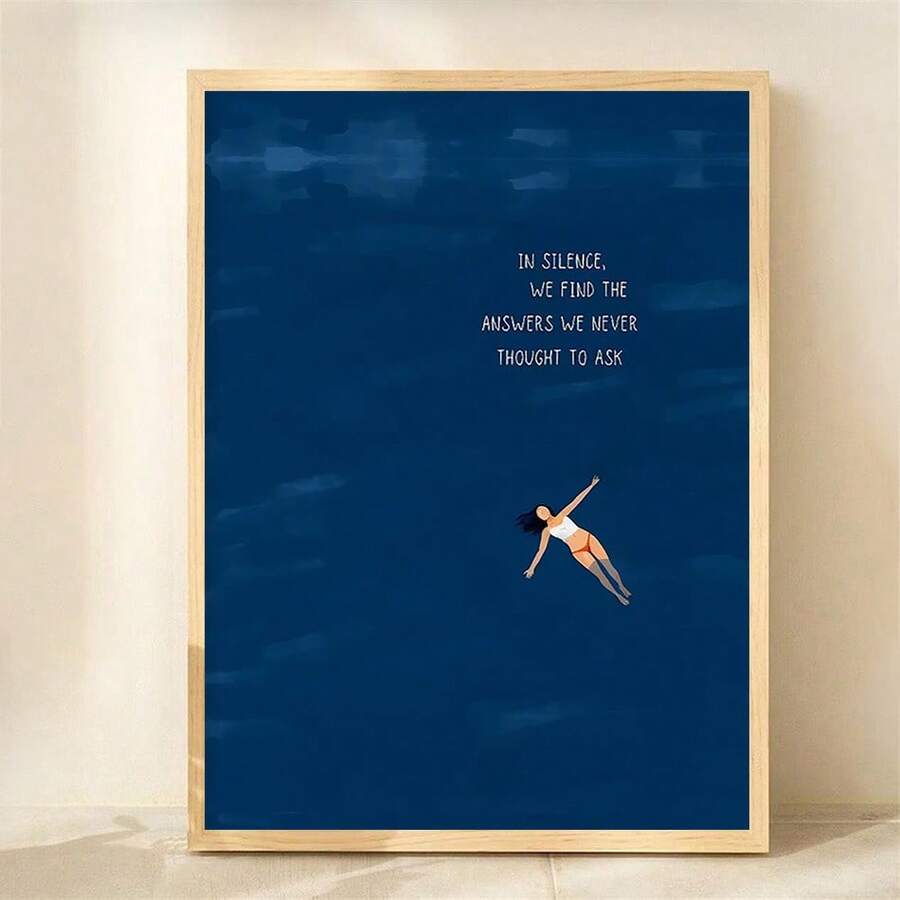 Vertical navy quote print with floating woman in a light wood frame
