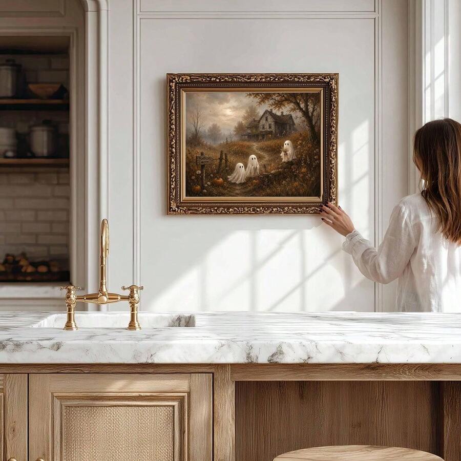 Vintage ghost cottage canvas print in an ornate gold frame shown on a kitchen wall