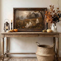 Vintage ghost cottage canvas print in a dark ornate frame above a Halloween console