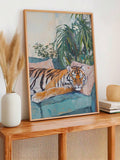 Tan framed resting tiger print styled on a wood console table