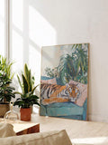 Tiger canvas wall art leaning in a sunny indoor plant corner
