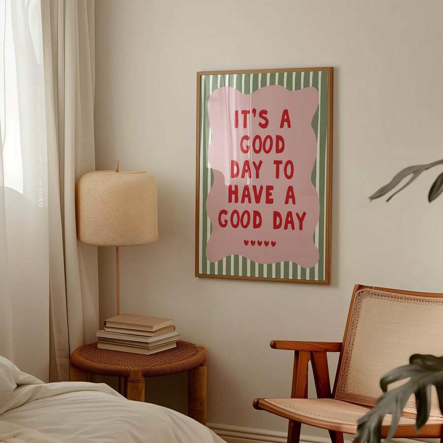Good day quote wall art hanging beside a bed with a lamp, books, and cane chair