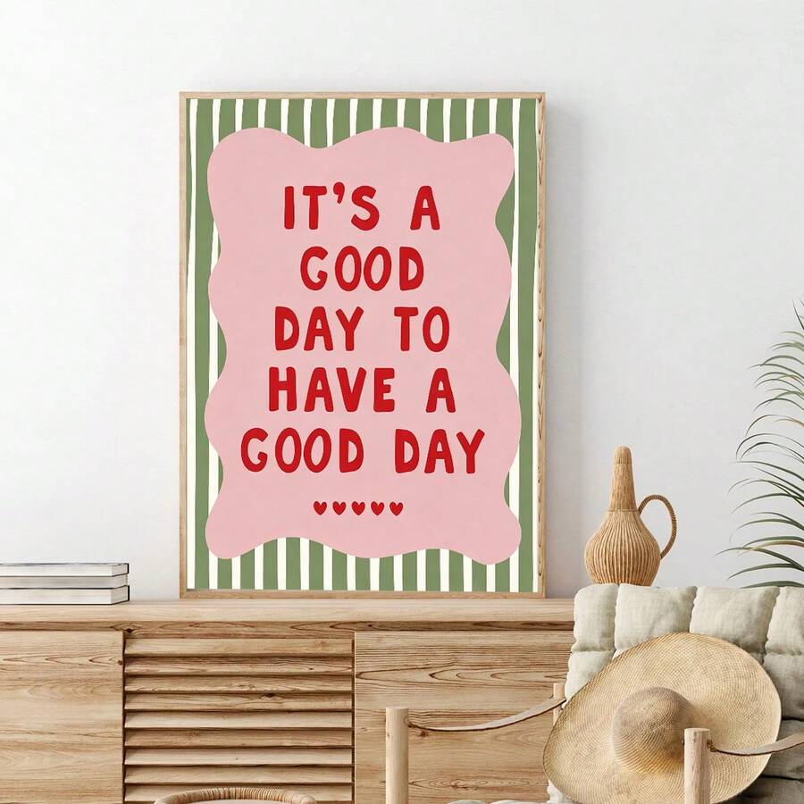 Pink and green motivational print displayed above a wood sideboard with woven decor