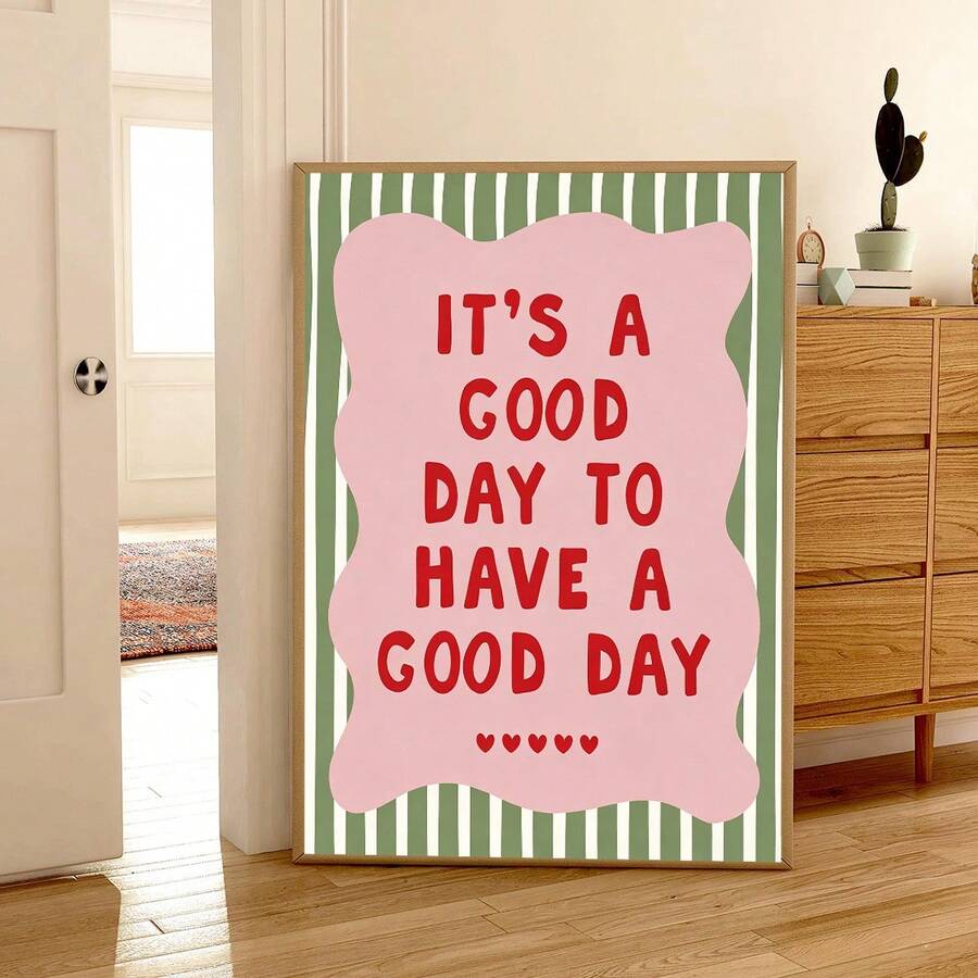 Large framed good day artwork leaning near a doorway, wood cabinet, and potted cactus