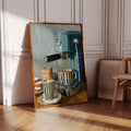 Framed espresso still life leaning against paneled walls near a cane chair