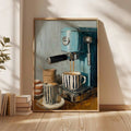 Framed turquoise espresso artwork leaning beside stacked books under leafy shadows