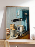 Turquoise coffee machine wall art displayed on a wood console beside a white vase