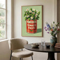 Framed tomato paste floral print above a round dining table by a window