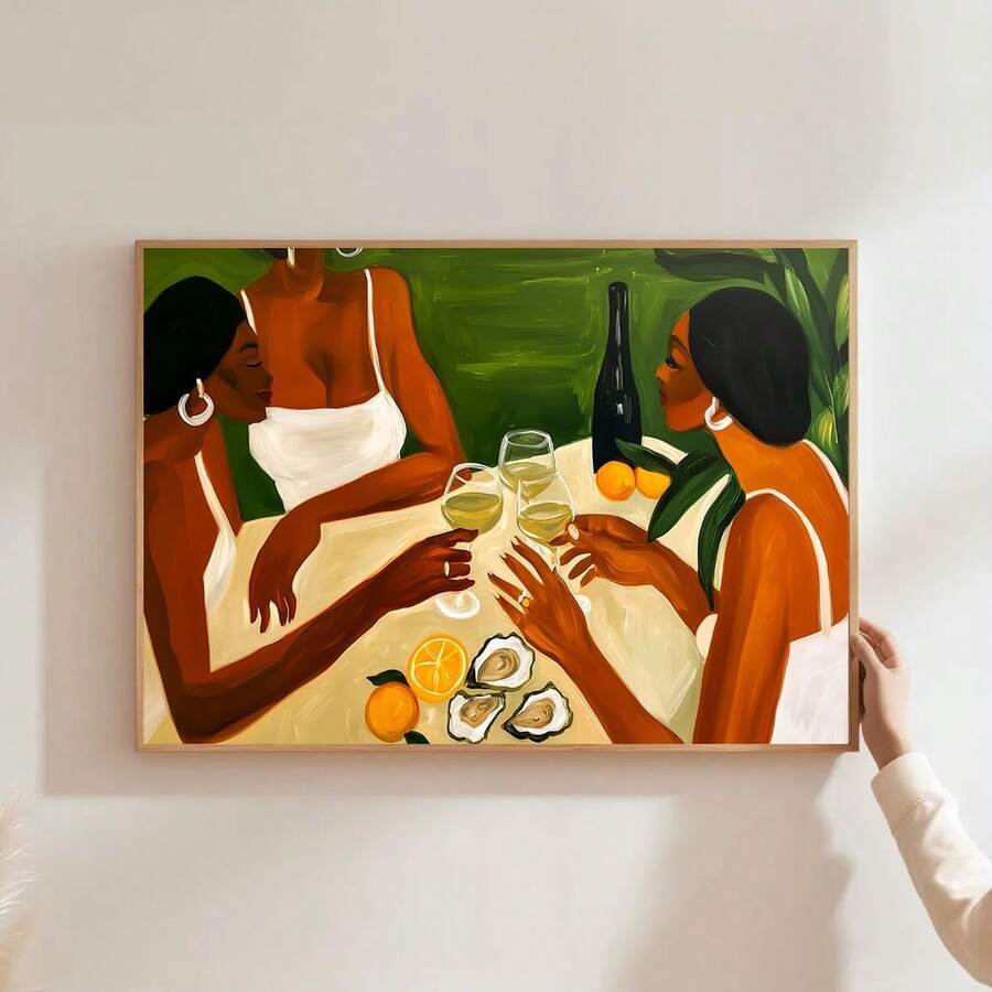 Framed artwork of three women sharing wine, oysters and citrus above a wood kitchen counter