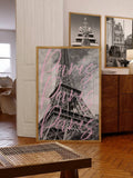 Framed Eiffel Tower print with pink Paris lettering beside a dining room gallery wall