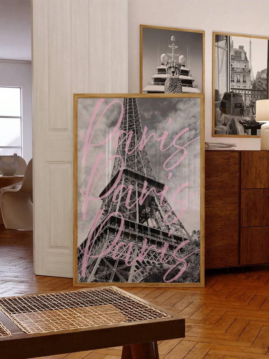 Framed Eiffel Tower print with pink Paris lettering beside a dining room gallery wall