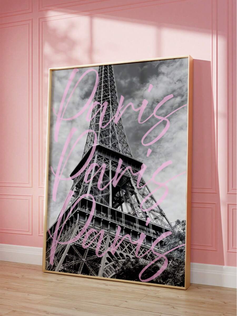 Close angled view of framed Eiffel Tower print with pink Paris script against a pink wall