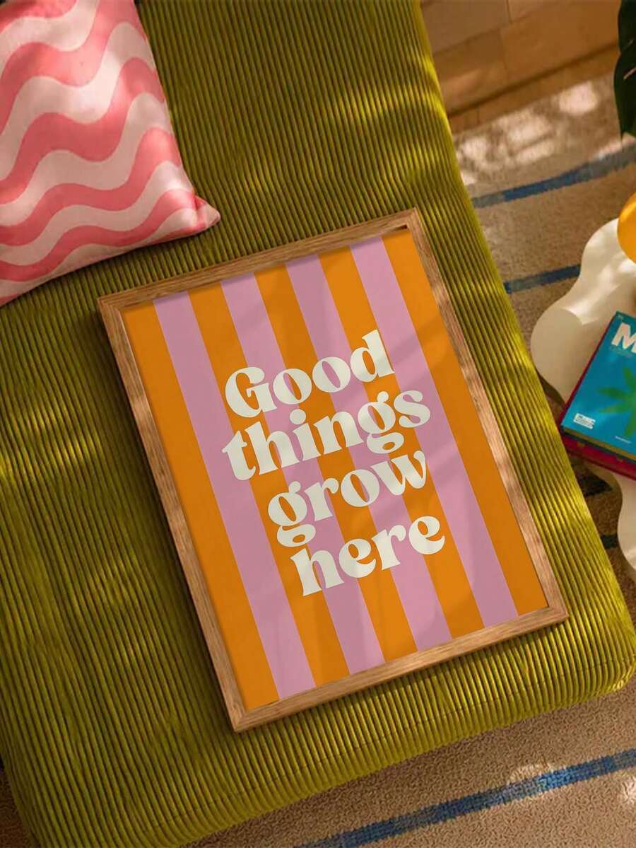 Natural frame Good things grow here artwork displayed on a green corduroy sofa
