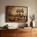 Warm wood framed ghost and pumpkin Halloween artwork above a sunlit walnut console