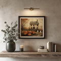 Black matted haunted house Halloween print beneath a brass picture light