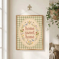 Cottage-style home sweet home floral artwork hanging by wire near a window