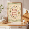 Framed home sweet home bird and flower sampler on a bright kitchen counter