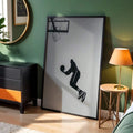 Monochrome basketball action poster in a black frame in a bedroom corner