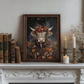 Highland cow autumn poster in a dark frame beside antique books and candles