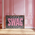 Pink SWAG leopard print canvas poster staged in a rosy paneled room