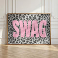 Large pink SWAG typography leopard artwork leaning in an ornate white room